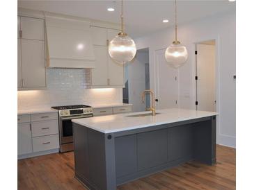 Elegant kitchen featuring a spacious island, stainless steel appliances, and modern pendant lighting at 289 White St # 3, Marietta, GA 30060