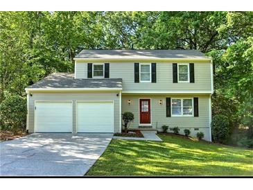 Charming two-story home with a well-manicured lawn, a two-car garage, and a welcoming red front door at 4378 Heritage Glen Ct, Marietta, GA 30068