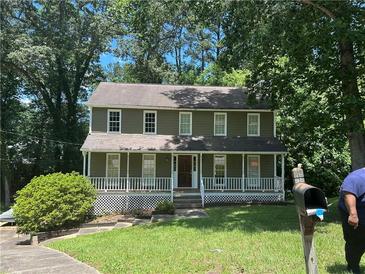 Charming two-story home with a covered porch, and well-maintained landscaping at 3808 Holy Cross Ct, Decatur, GA 30034