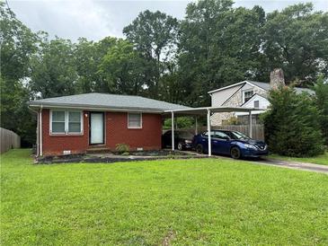 Charming brick home with a well-manicured lawn and convenient carport at 2431 Crestview Ave, Decatur, GA 30032