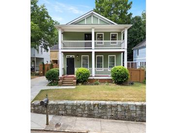 Charming two-story home with a double front porch, green siding, and well-maintained landscaping at 187 Vanira Se Ave, Atlanta, GA 30315