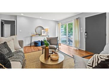 Comfortable living room featuring a textured rug, modern furniture, and natural light at 3048 Briarcliff Ne Rd # 8, Atlanta, GA 30329