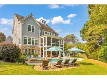 Stunning backyard with a private pool, patio, and lush landscaping, perfect for outdoor entertaining at 3185 Casteel Ne Rd, Marietta, GA 30062