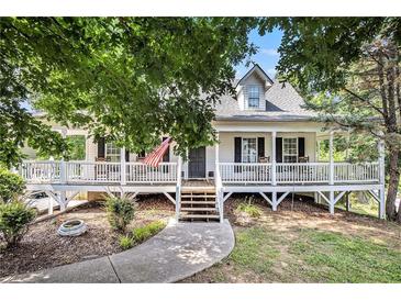 Charming home with inviting front porch, white railings, and a well-manicured yard at 47 Glen Ridge Dr, Villa Rica, GA 30180