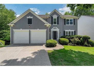 Charming two-story home featuring a two-car garage, well-maintained landscaping, and inviting curb appeal at 1095 Lyndhurst Way, Roswell, GA 30075
