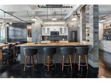 Modern kitchen featuring an island with seating, granite countertops, and stainless steel appliances at 878 Peachtree St # 601, Atlanta, GA 30309