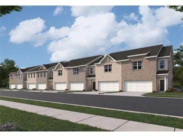 Newly constructed townhomes feature brick exteriors, two-car garages, and professionally landscaped surroundings at 1221 Fagiolo St, Mcdonough, GA 30253