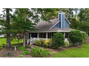 Charming blue two-story home with a landscaped front yard and covered front porch at 233 Oakridge Se Dr, Cartersville, GA 30121
