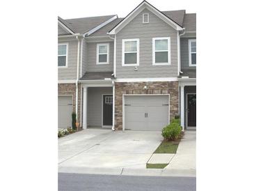 Inviting townhome with stone accents, neutral siding, and a convenient two-car garage at 1942 Dillon Dr, Lithonia, GA 30058