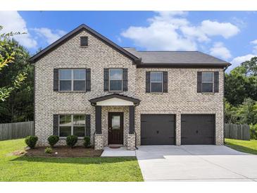 Charming two-story brick home with a two-car garage and well-maintained landscaping at 12225 Anchor Way, Hampton, GA 30228