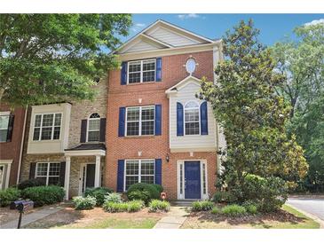 Attractive brick townhome with a well-maintained lawn, beautiful landscaping, and a charming entryway at 626 Pecan Knoll Dr # 13, Marietta, GA 30008