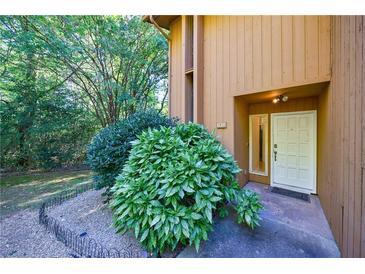 Inviting front entrance with well-maintained landscaping and a modern front door at 838 Lake Hollow Sw Blvd, Marietta, GA 30064
