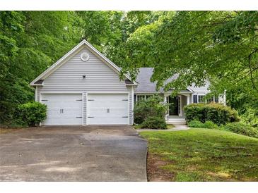 Charming home with two-car garage, mature trees, and well-maintained landscaping at 245 London Ln, Hiram, GA 30141