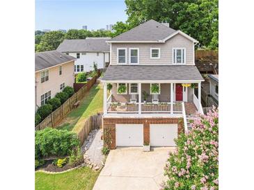 Charming two-story home featuring a front porch, two-car garage, and landscaped front yard at 218 South Se Ave, Atlanta, GA 30315