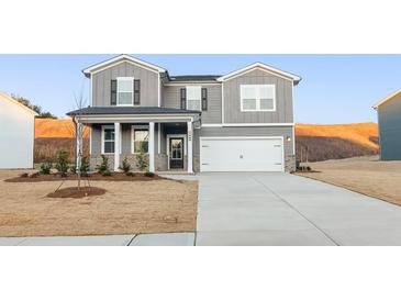 Charming two-story home featuring gray siding, a well-manicured lawn, and a spacious driveway at 4036 Trimrose Ct, Atlanta, GA 30349