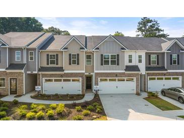 Attractive townhomes featuring mixed materials and attached garages with nice landscaping at 11408 Gray Branch Dr, Lawrenceville, GA 30045