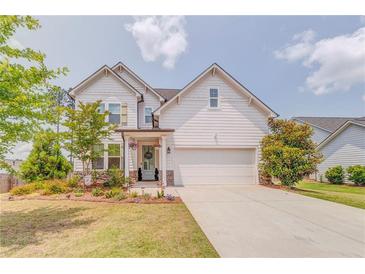 Charming two-story home featuring white siding, a two-car garage, and a beautifully landscaped front yard at 28 Rolling Rock Way, Dallas, GA 30157
