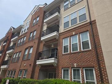 Beautiful multi-story brick building with stucco accents and black iron balconies at 1850 Cotillion Dr # 2204, Atlanta, GA 30338