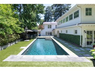 Inviting backyard pool with well-manicured landscaping and patio furniture, perfect for outdoor entertaining at 204 Rumson Ne Rd, Atlanta, GA 30305