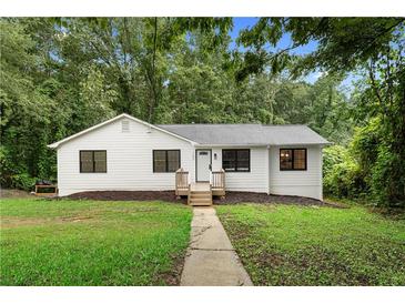 Charming renovated home featuring a landscaped yard and inviting front porch at 160 Pine Grove Dr, Canton, GA 30114