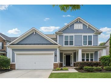 Charming two-story home with a well-maintained lawn and a classic suburban facade at 303 Ridgewood Trl, Canton, GA 30115