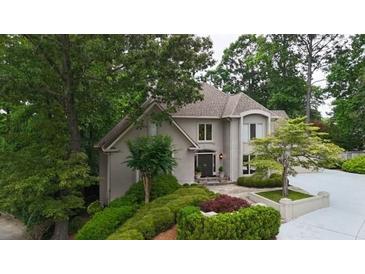 Charming home featuring manicured landscaping, mature trees, and a welcoming front entrance at 3616 Blakeford Ct, Marietta, GA 30062