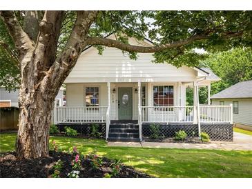 Charming home featuring a welcoming front porch, well-maintained lawn, and beautiful landscaping at 124 Richmond Se St, Atlanta, GA 30312