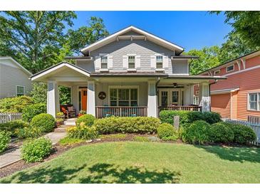 Charming gray two-story home featuring a well-manicured lawn, lush landscaping, and inviting front porch at 629 2Nd Avenue, Decatur, GA 30030