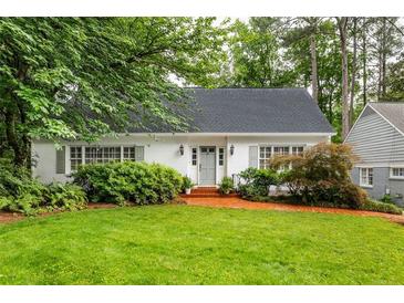 Charming single-story home boasts a lush front yard and a welcoming brick walkway leading to the front door at 956 Clifton Ne Rd, Atlanta, GA 30307