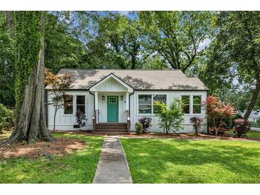 Charming renovated bungalow featuring a new roof, stylish green door, and a lush front yard at 2485 Hillside Ave, Decatur, GA 30032