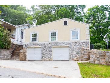 Two-story garage with stone base and neutral siding at 3349 Lavista Dr, Atlanta, GA 30354