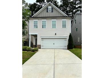 Charming two-story home featuring a two-car garage and manicured landscaping at 4450 Richmond Ct, Stone Mountain, GA 30083
