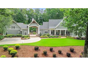 Stately home featuring a portico over the driveway and meticulous landscaping at 114 Trinity Hollow Dr, Canton, GA 30115