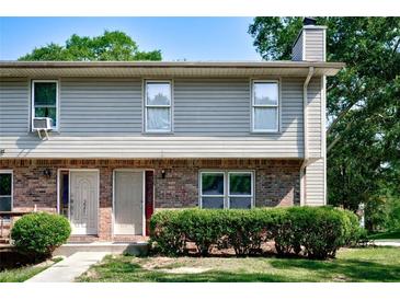 Charming two-story townhouse featuring brick and siding exterior with well-maintained landscaping at 1215 Willow Creek Nw Ct, Conyers, GA 30012