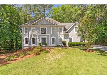 Charming two-story traditional home with a manicured lawn and gray painted brick exterior at 5396 Turnbill Nw Pt, Acworth, GA 30101