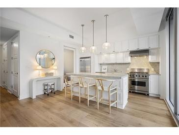 Bright kitchen features stainless steel appliances, marble counters, and counter seating at 1820 Peachtree Nw St # 303, Atlanta, GA 30309