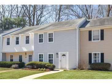 Charming townhouse with light blue siding, white trim, and well-maintained landscaping at 834 Heritage Sq, Decatur, GA 30033