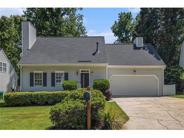 Charming single-Gathering home with manicured lawn, grey siding, and a two-car garage at 1175 Haven Brook Way, Atlanta, GA 30319