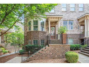 Charming brick townhome with bay window and welcoming front entrance in a desirable community at 1216 Virginia Ne Ct # 8, Atlanta, GA 30306