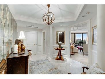 Elegant foyer features marble floors, decorative lighting, and an open view into the living space at 2660 Peachtree Nw Rd # 10H, Atlanta, GA 30305