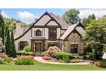 Charming home showcasing a stone and tan exterior with a meticulously landscaped front yard and inviting front entrance at 3770 Riverly Trce, Marietta, GA 30067