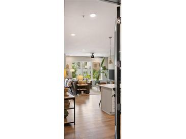 Open-concept living room with modern finishes, abundant natural light, and sleek hardwood flooring at 22 Airline Ne St # 201, Atlanta, GA 30312