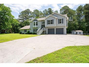 Charming two-story home features a spacious driveway and attached two-car garage at 76 Vaughn Ne Rd, Cartersville, GA 30121