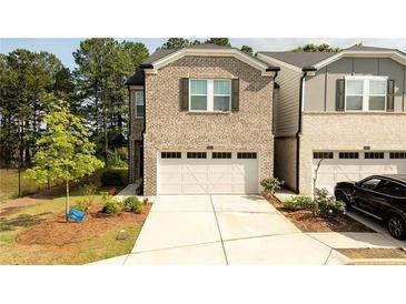 Charming two-story home with a two-car garage and well-manicured front yard at 1825 Villageside Ct, Lawrenceville, GA 30043