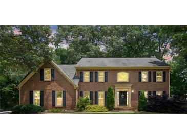 Charming two-story brick home featuring well-manicured landscaping and a welcoming front entrance at 3267 Remembrance Trce, Lawrenceville, GA 30044