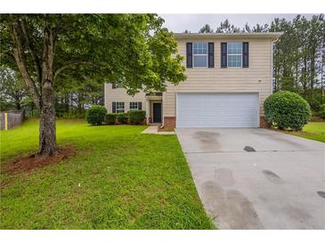 Charming two-story home featuring a two-car garage and a lush green lawn at 450 Pinevale Ct, Atlanta, GA 30349