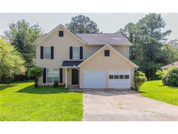 Inviting two-story home featuring a well-maintained lawn and a convenient two-car garage at 9542 Canvasback Ct, Jonesboro, GA 30238