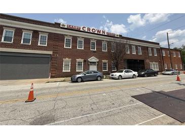 Exterior view of Candy Crown Food building with parking and a brick facade, featuring a vintage industrial design at 320 Martin Luther King Jr Dr # 5, Atlanta, GA 30312