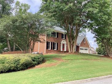 Traditional two-story brick home with black shutters and mature landscaping at 3243 Northbrook Dr, Atlanta, GA 30341