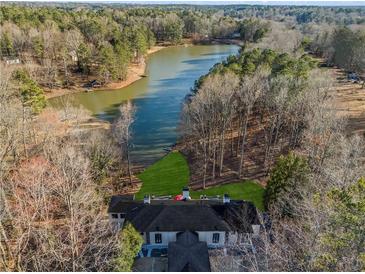 Breathtaking aerial view of the home and its serene waterfront location along the winding lake at 1126 Wedgefield Sw Dr, Marietta, GA 30064